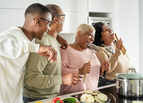 Afro-American family cooking Vegetarian food and having a good time